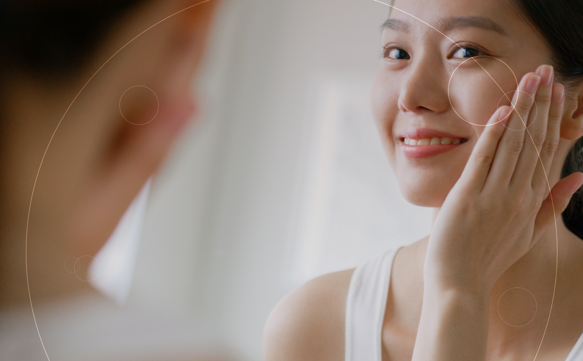 Smiling Woman taking care of her face in front of mirror